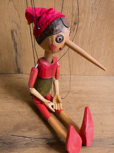 Wooden Pinocchio in red hat